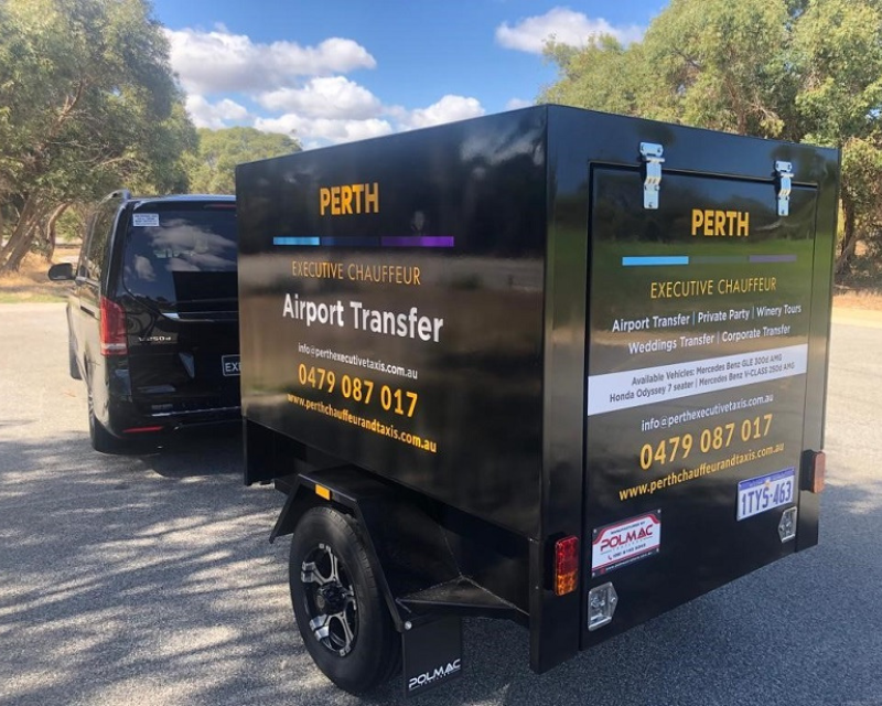 Extra luggage trailer attached behind chauffeured van transport asset